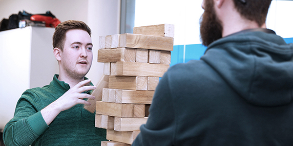 Workers taking a break from work and plays Jenga.  