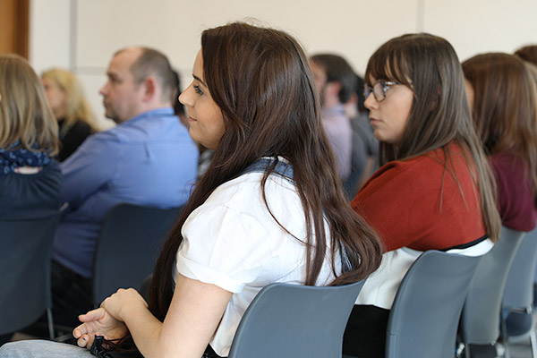 Women sitting in a conference room. 