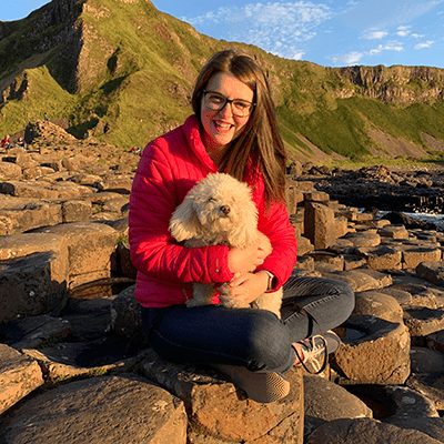 Rachel and her dog, Harry,  rest during their walk along the North Coast. 