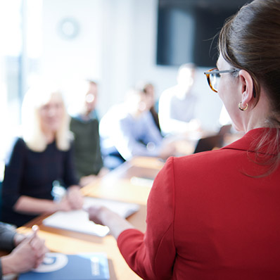 Woman presenting at a meeting. 