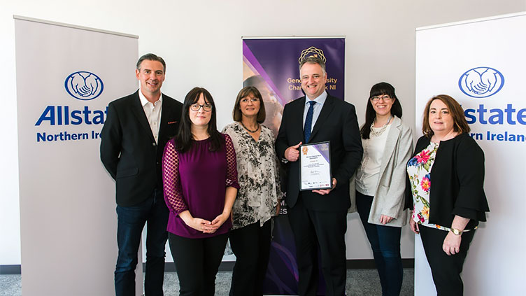 Allstate Ni employees standing together and holding the Bronze award. 