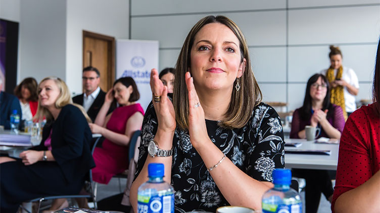 Members attending conference are clapping recipients of presented awards. 