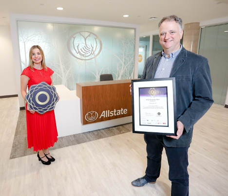John Healy holding the Silver Diversity Mark Awayd and is standing with Christine White.