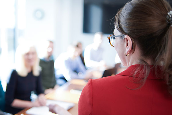 A woman presents at a meeting. 